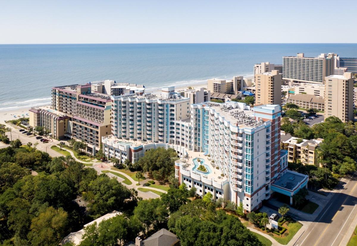 Aerial view of Horizon at 77th resort in Myrtle Beach with oceanfront condos and pools, offering ideal lodging for visitors attending Myrtle Beach Jeep Jam 2025